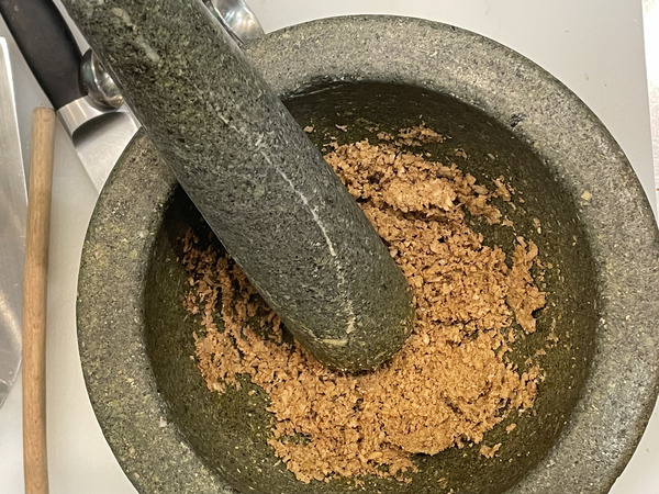 a Thai style pestle and mortar with green curry paste